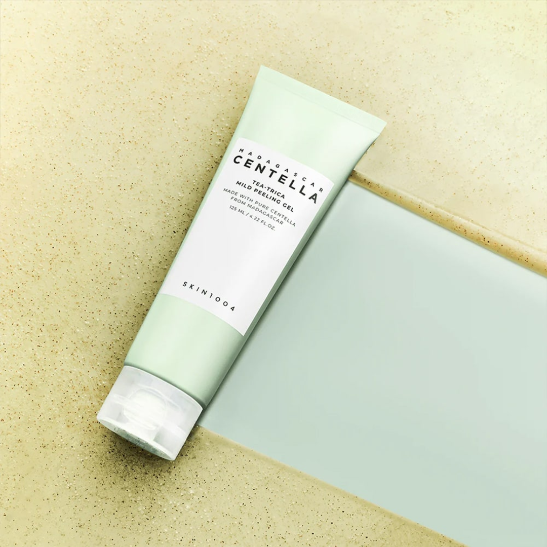 Skincare tube labeled 'Centella' on a peeling gel and green background