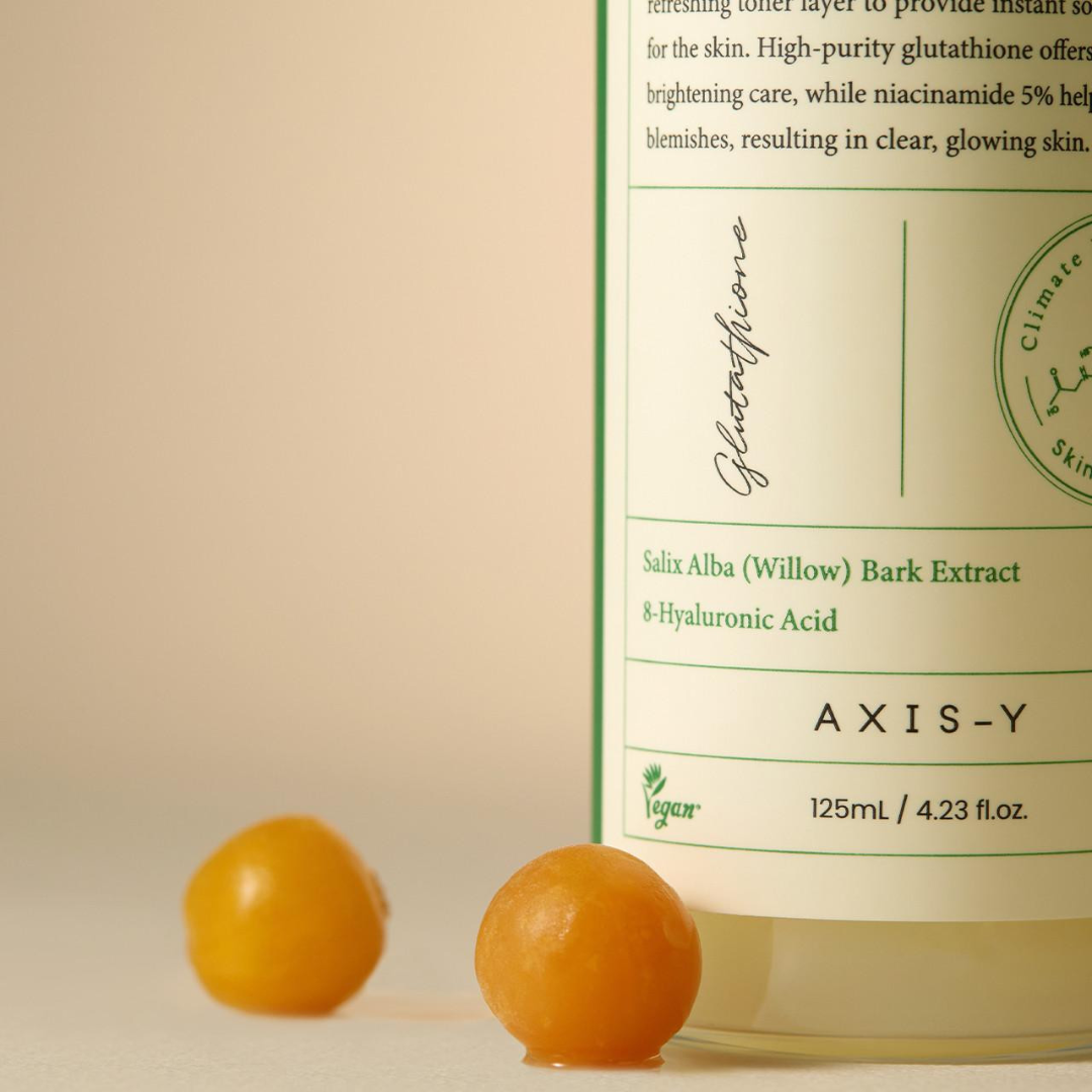  AXIS-Y skincare product with two orange balls on a beige background
