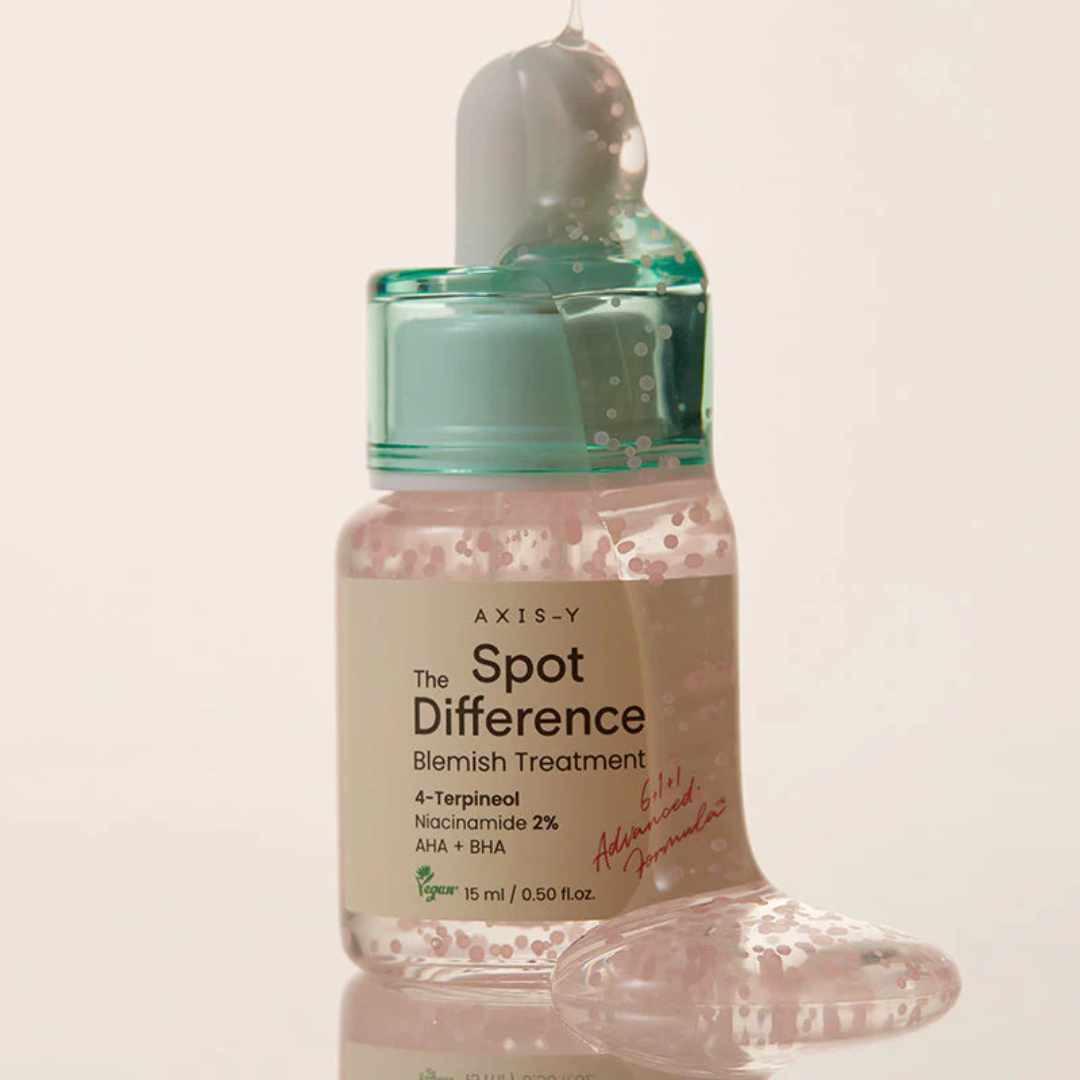 Bottle of Axis-Y Spot Difference Blemish Treatment on a light beige background