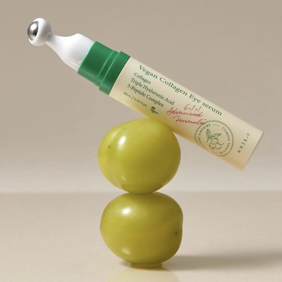 Vegan collagen eye serum bottle with green applicator on a beige background