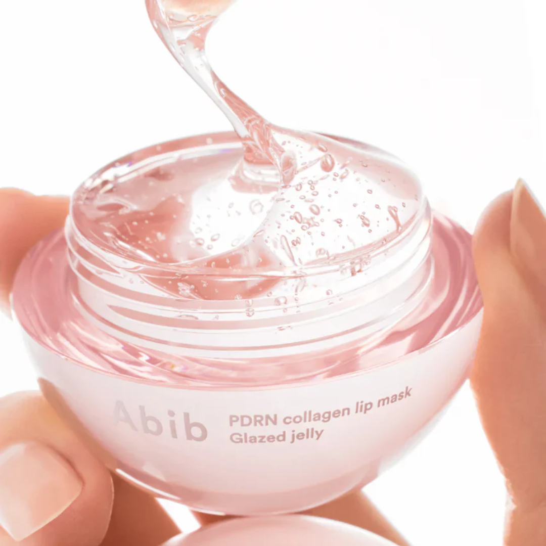 Pink lip mask with 'abib' branding being squeezed onto a white background