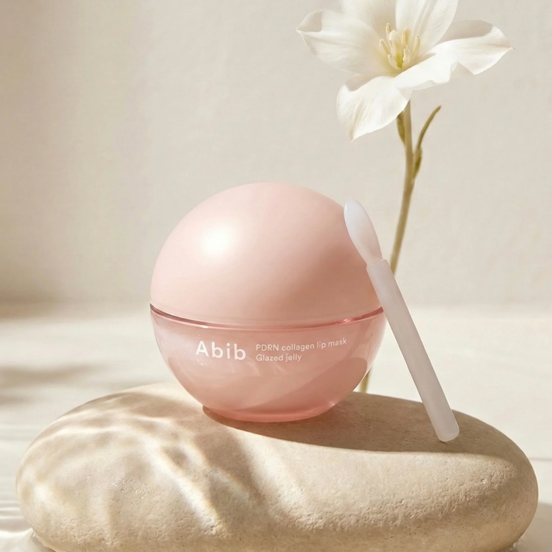 Pink lip mask with a white flower on a light background