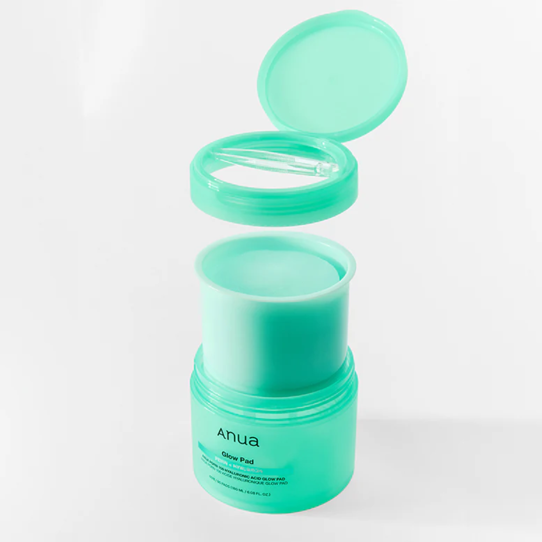 Green skincare product with open lid on a white background
