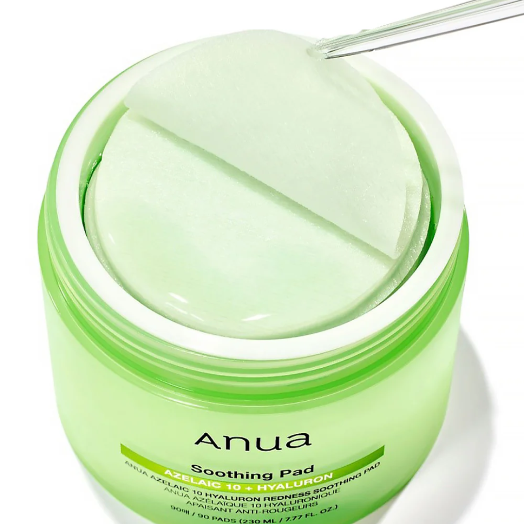 Green jar of Anua Soothing Pad with a pad on top against a white background