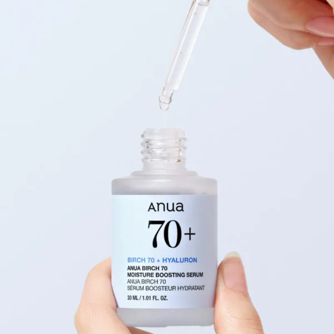 Anua Birch 70+ serum bottle with dropper on a light blue background