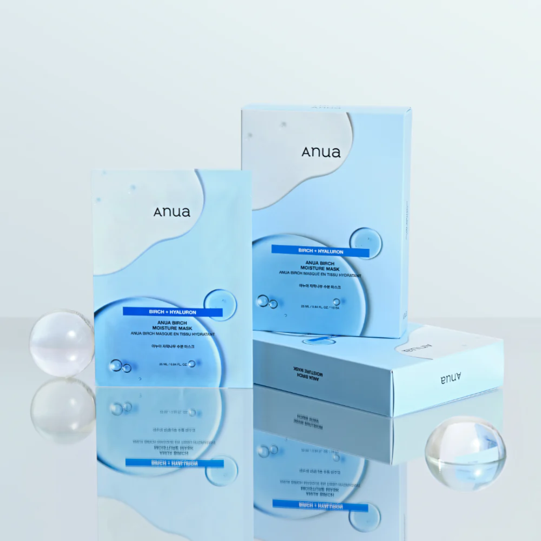 Anua skincare product packaging on a reflective surface with a light background