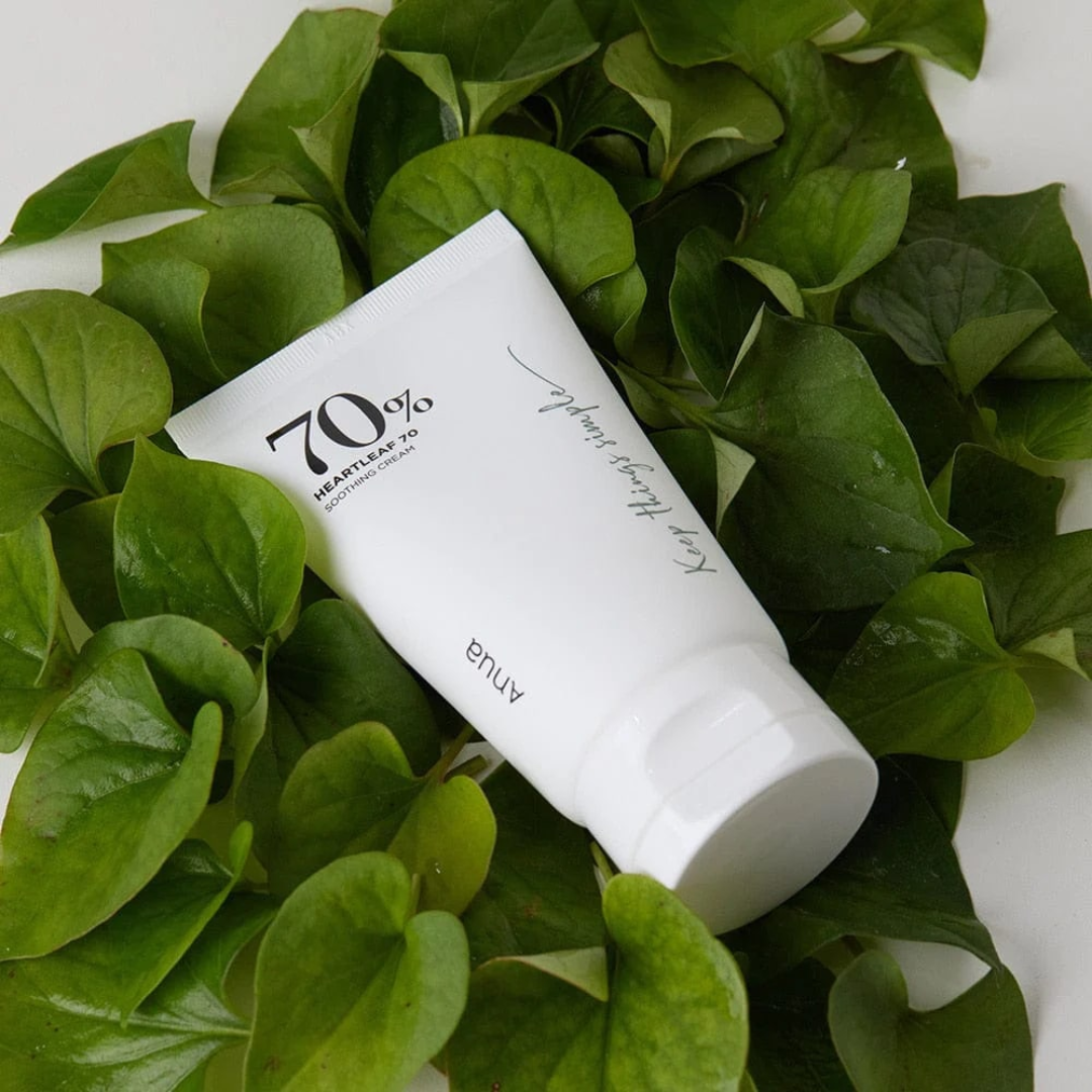 White skincare product with '70%' label on green leaves