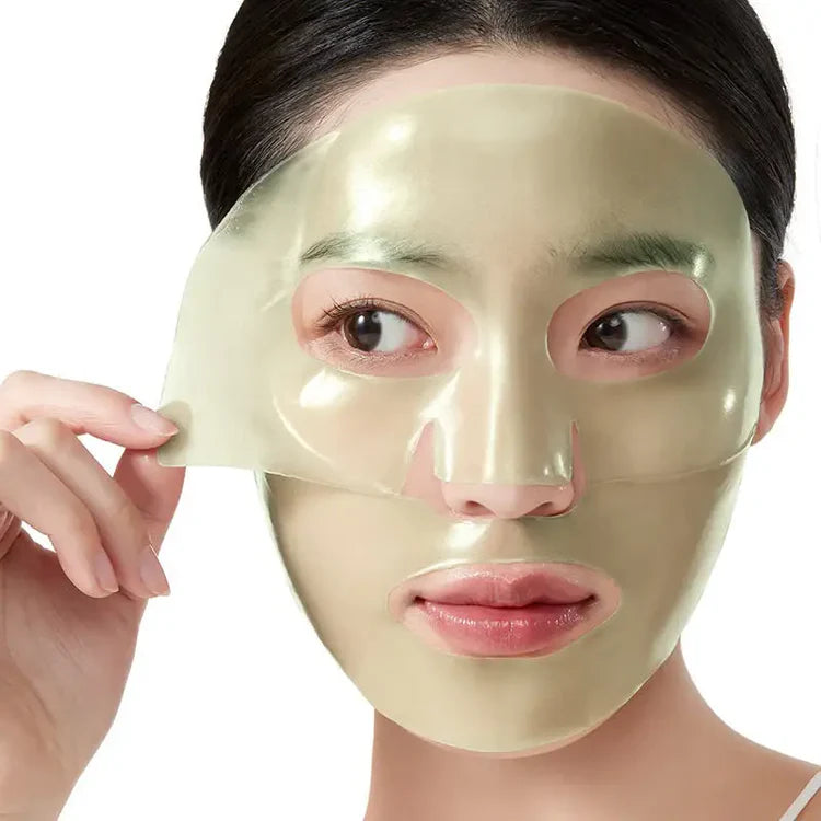 Anua green mask on a face being feeled off on a white background