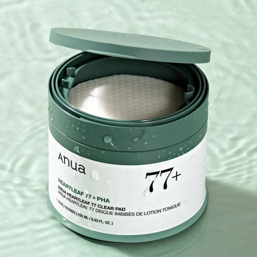 Anua 77+ clear pad container on a light green background