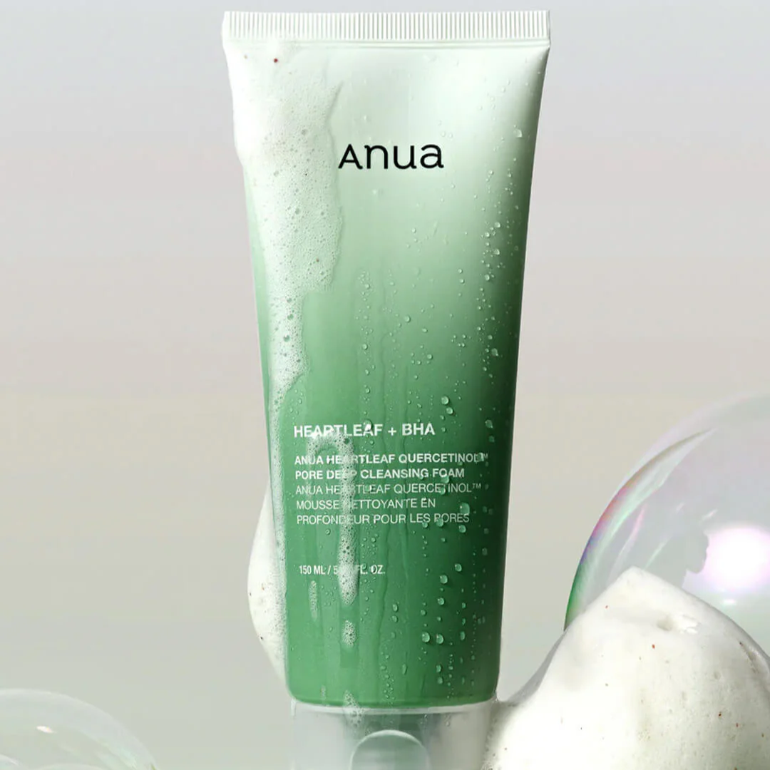 Green tube of Anua cleansing foam with a white cap on a light gray background