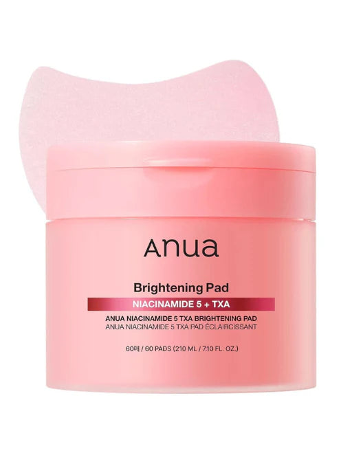 Anua brightening pad packaging with pink container and white applicator on a white background