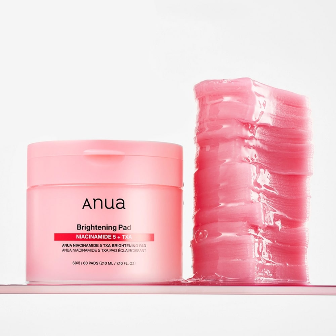 Pink skincare product jar and packets on a white background