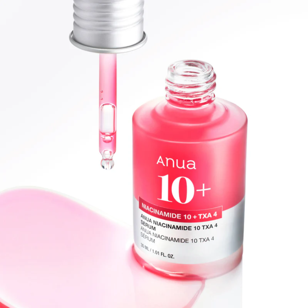 Pink serum bottle with dropper labeled 'Anua' on a white background