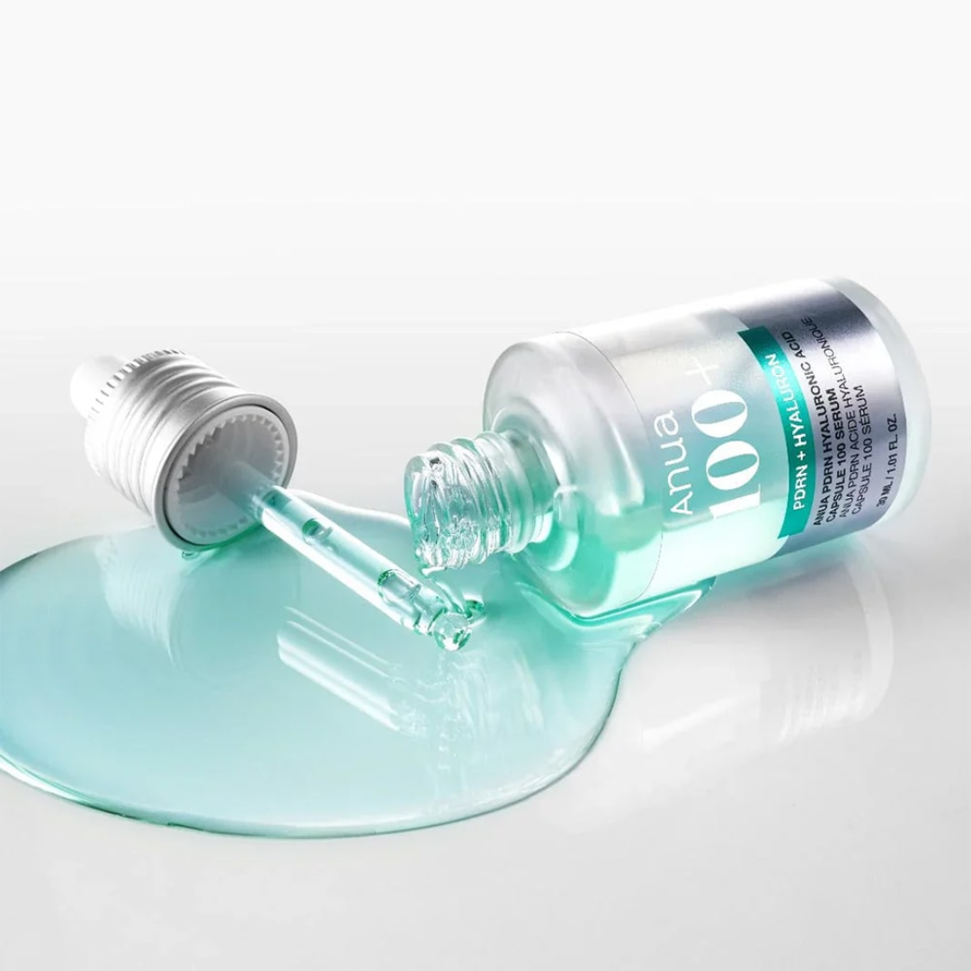 Anua skincare dropper bottle with blue liquid on a white background