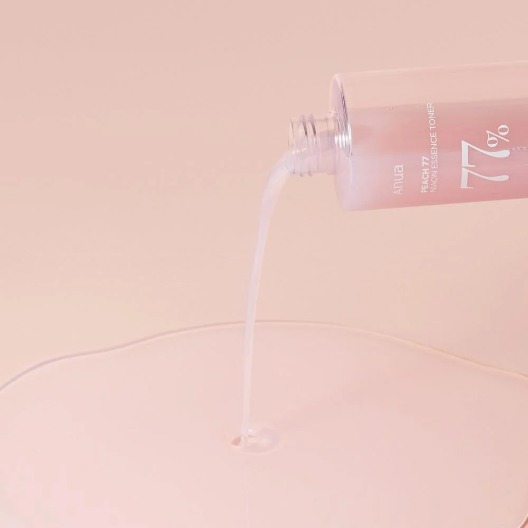Anua skincare product with a dropper on a pink background