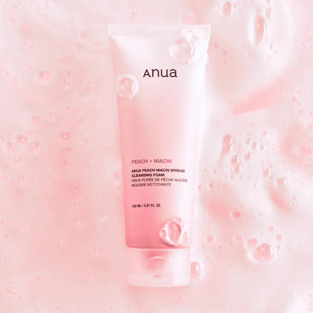 Anua peach and niacin facial product packaging on a pink bubble background