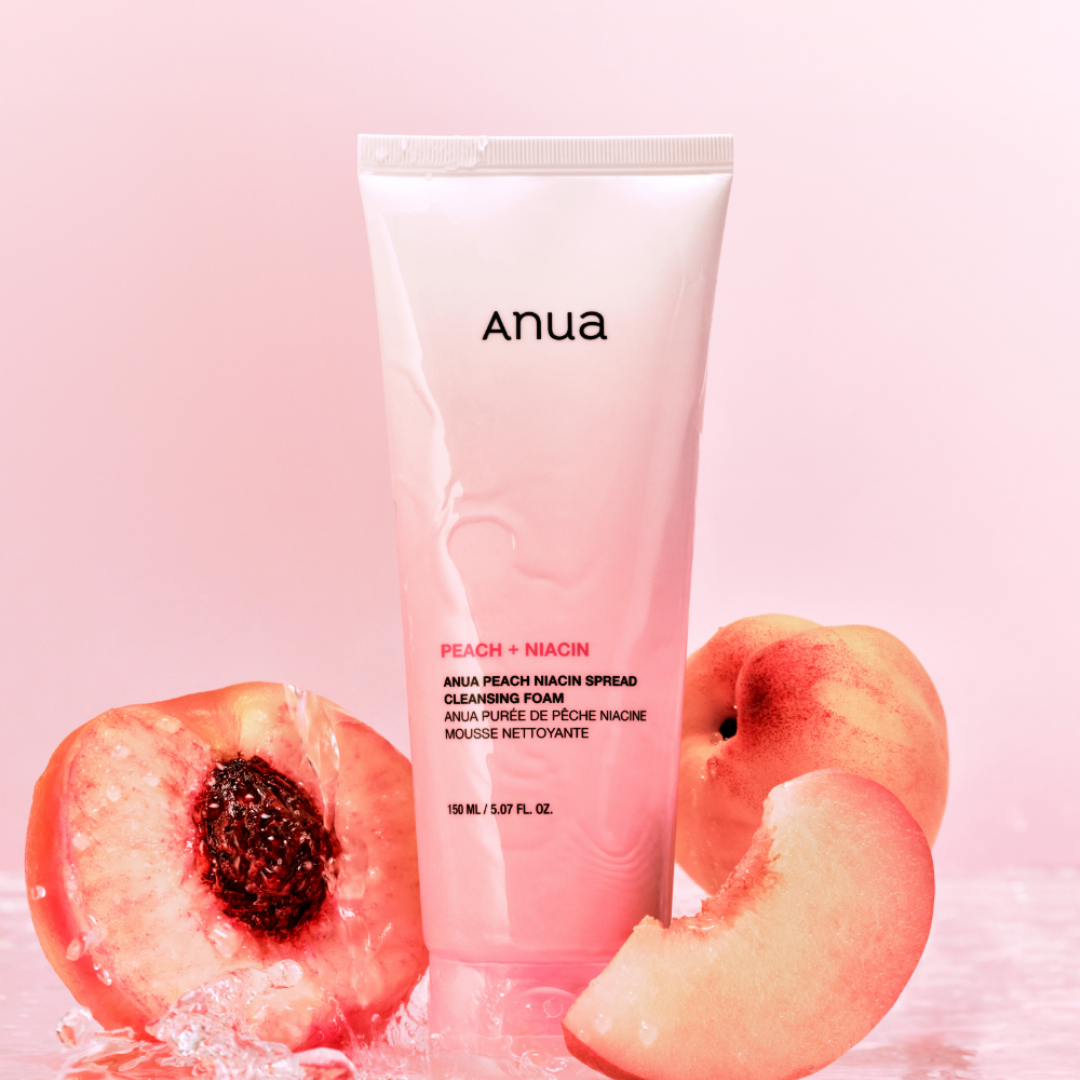 Anua peach niacin cleansing foam with a pink background and peaches.