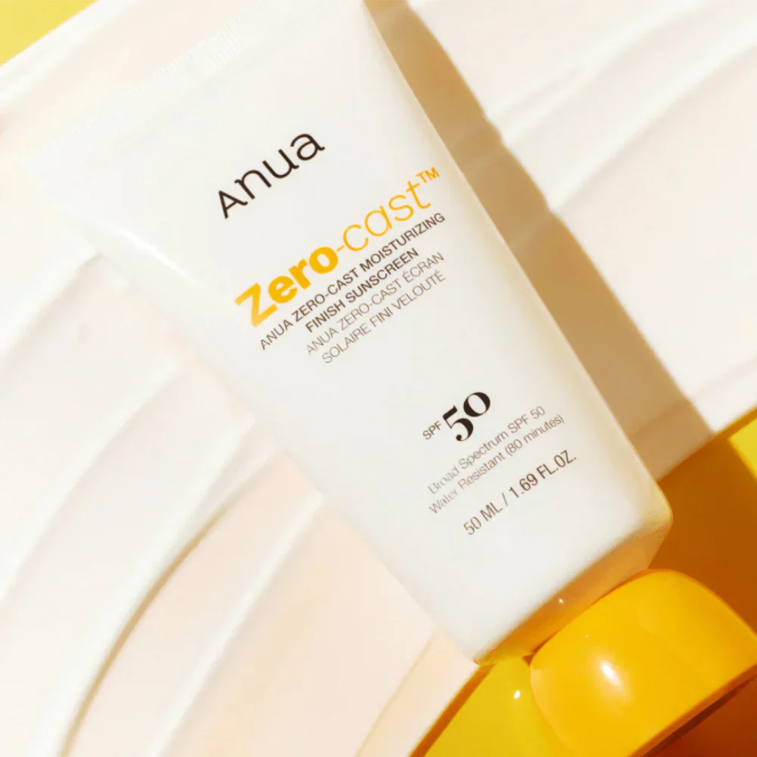 Anua Zero-Cast sunscreen bottle with yellow cap on a light background