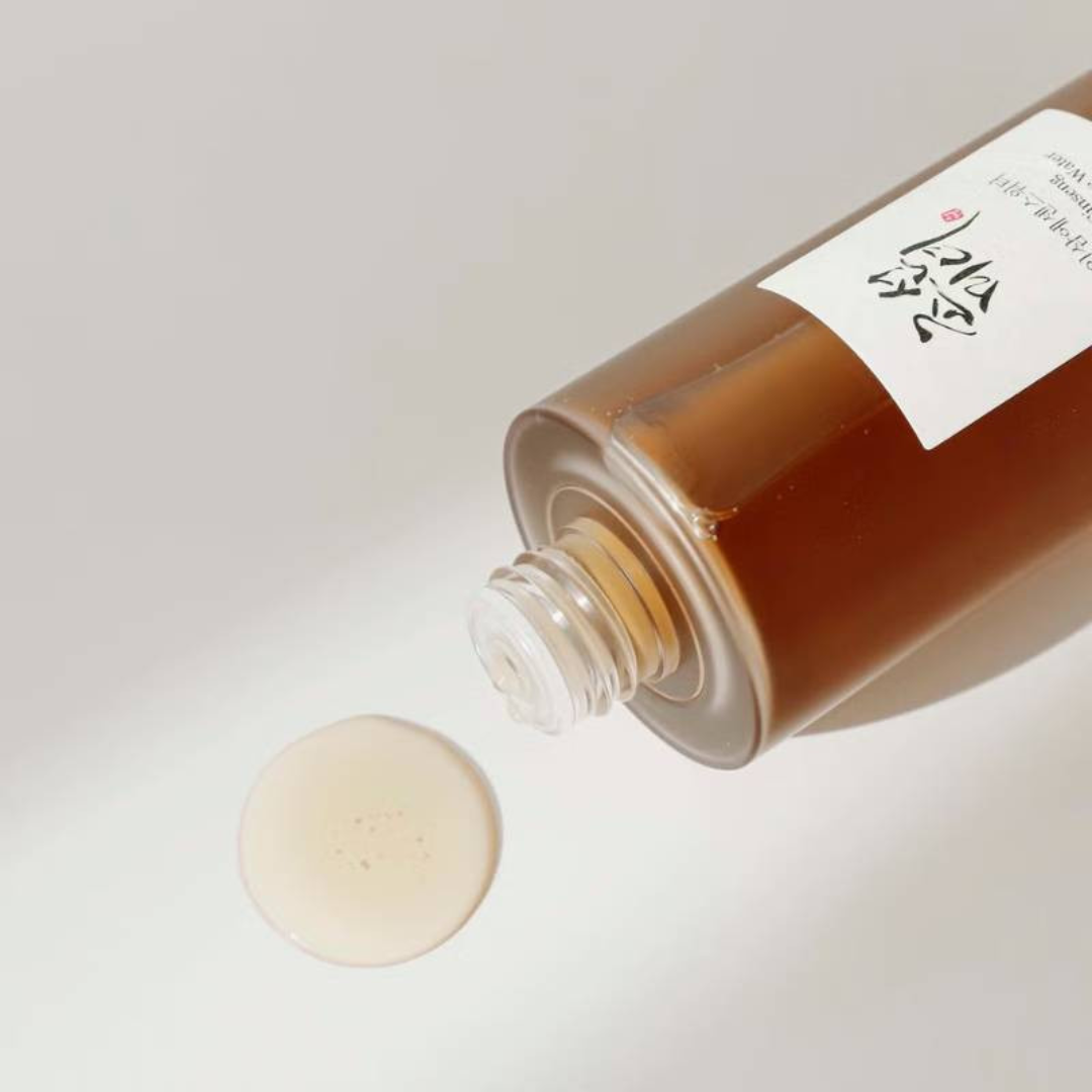 Bottle of brown liquid with a label on a light gray background