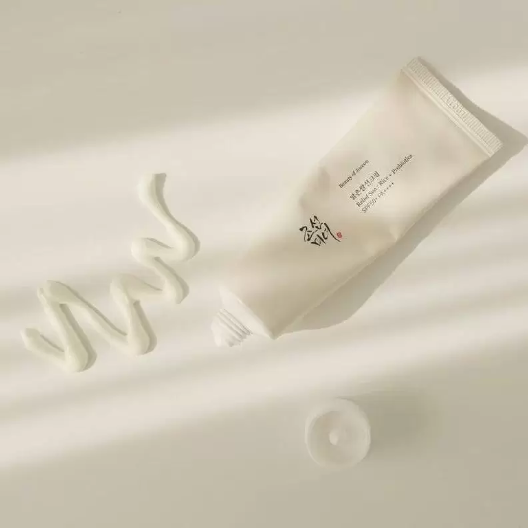 Cream container with white cream on a light beige background