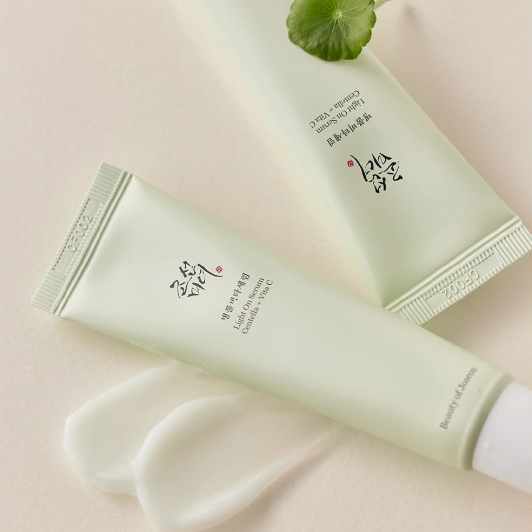 Two green skincare products with text on a light pink background