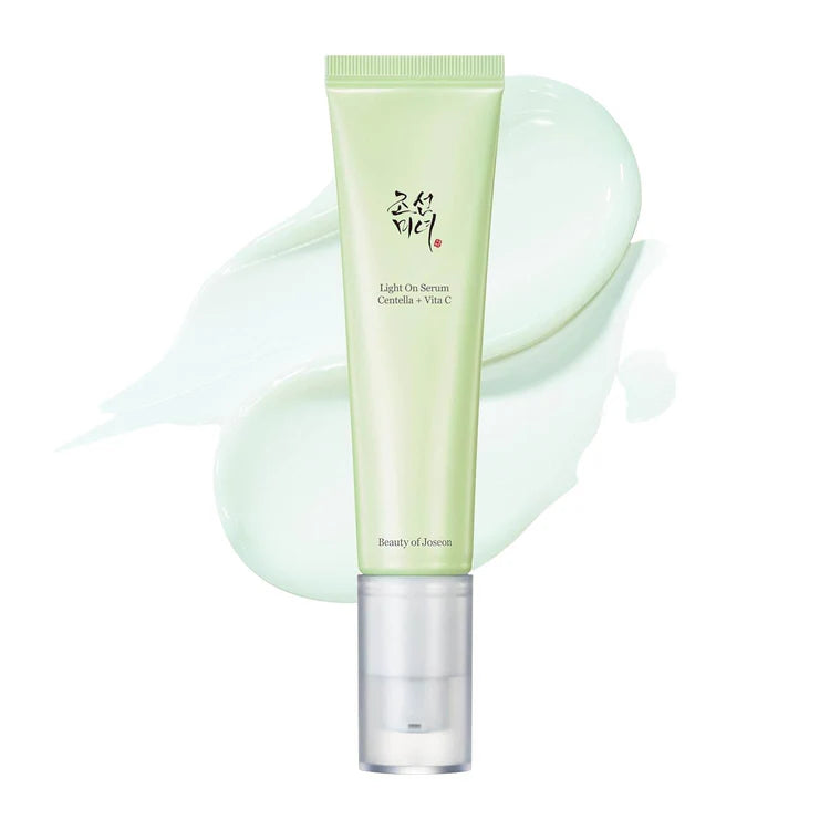 Skincare serum tube with a light green color on a white background