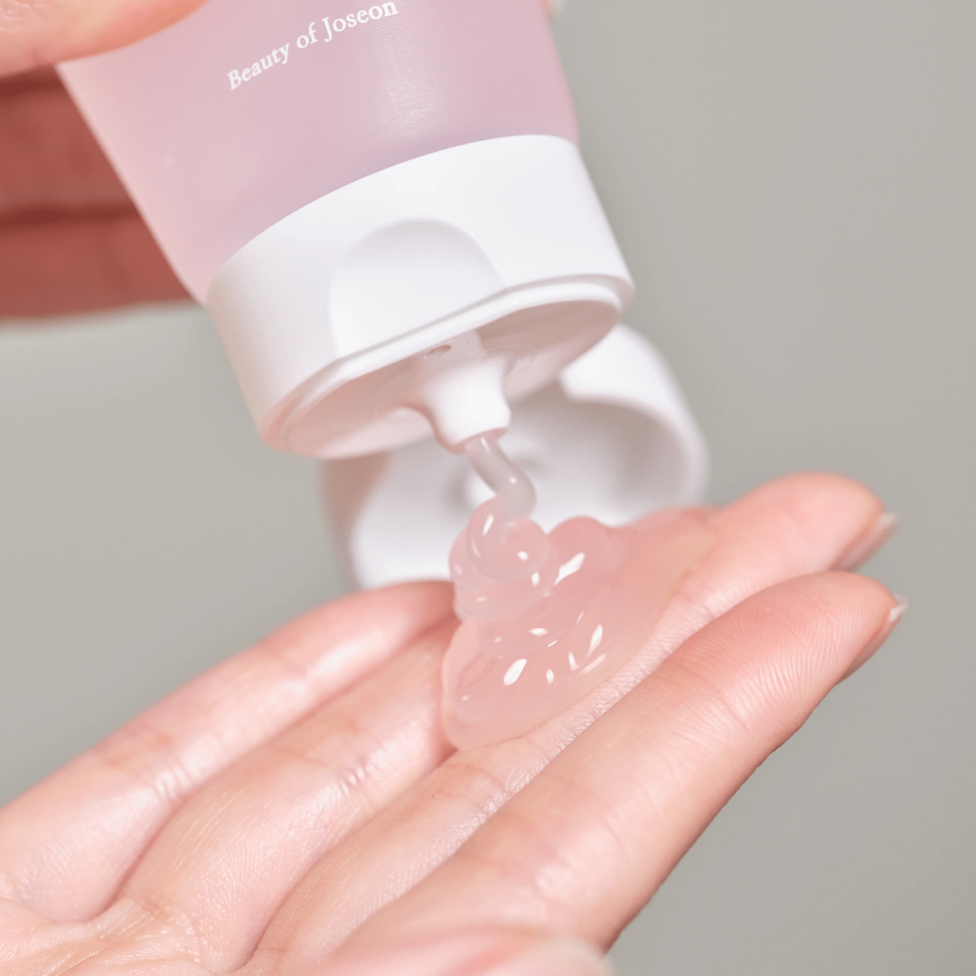 Pink skincare product being applied to a hand with 'Beauty of Joseon' branding.