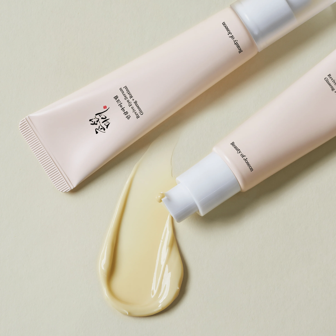 Two tubes of cream with a swatch on a light green background