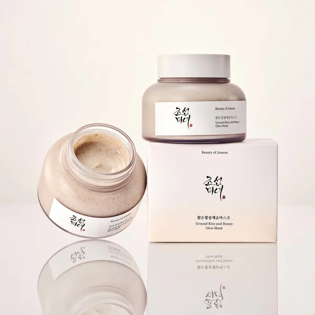 Beauty product with open jar and packaging on a light background