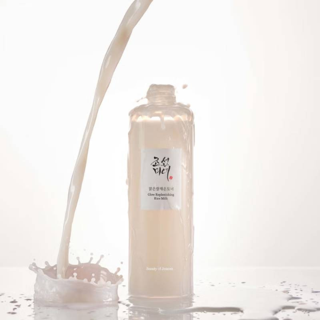 Skincare bottle with liquid being poured onto a white surface
