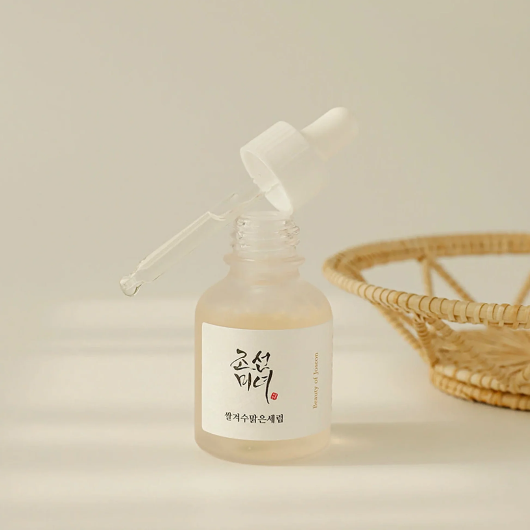 Skincare serum bottle with dropper on a beige background