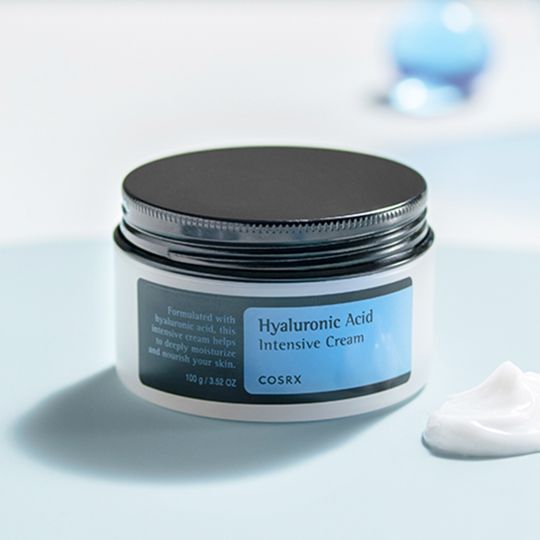 Cosrx Hyaluronic Acid Intensive Cream jar on a light blue background
