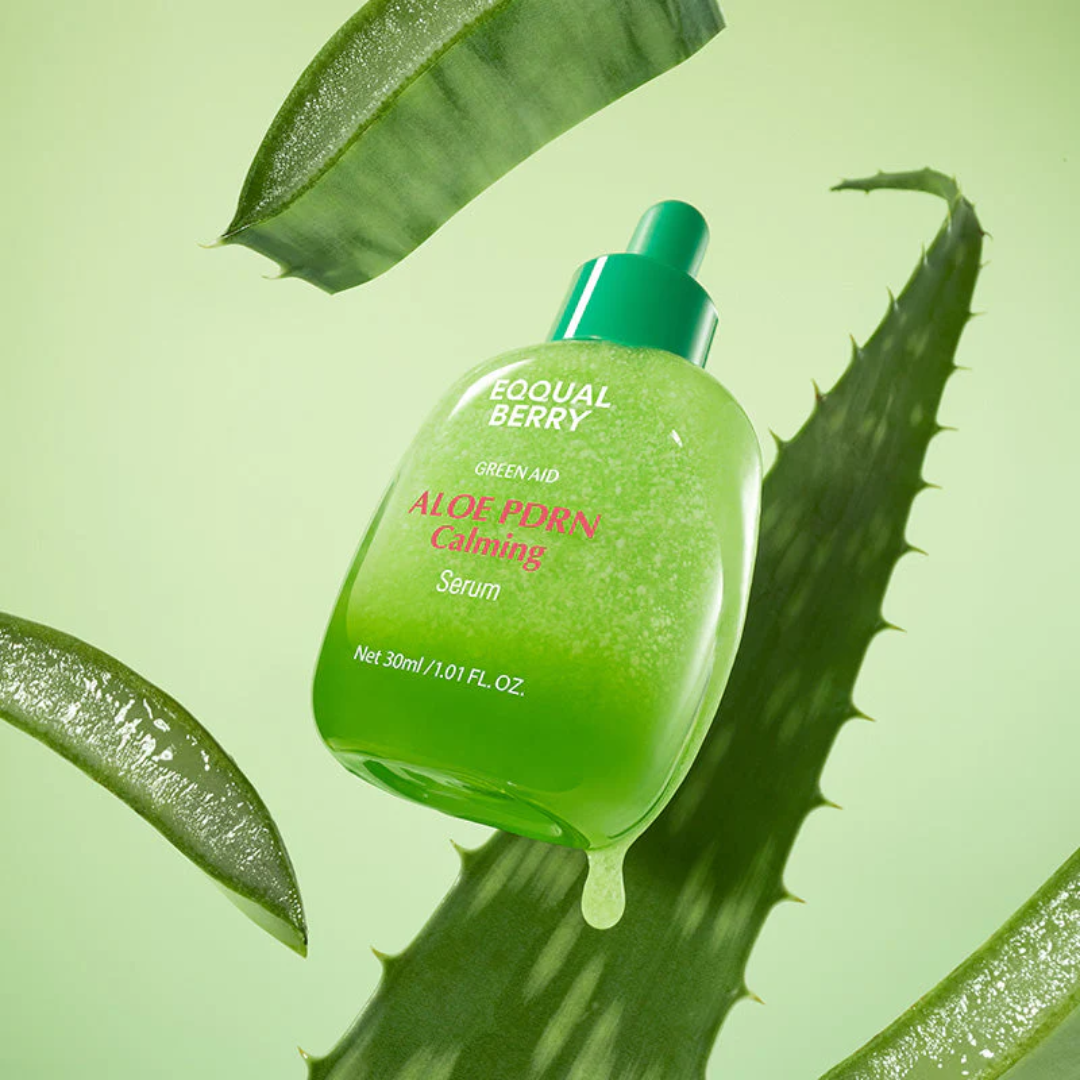 Green aloe vera serum bottle with leaves on a green background