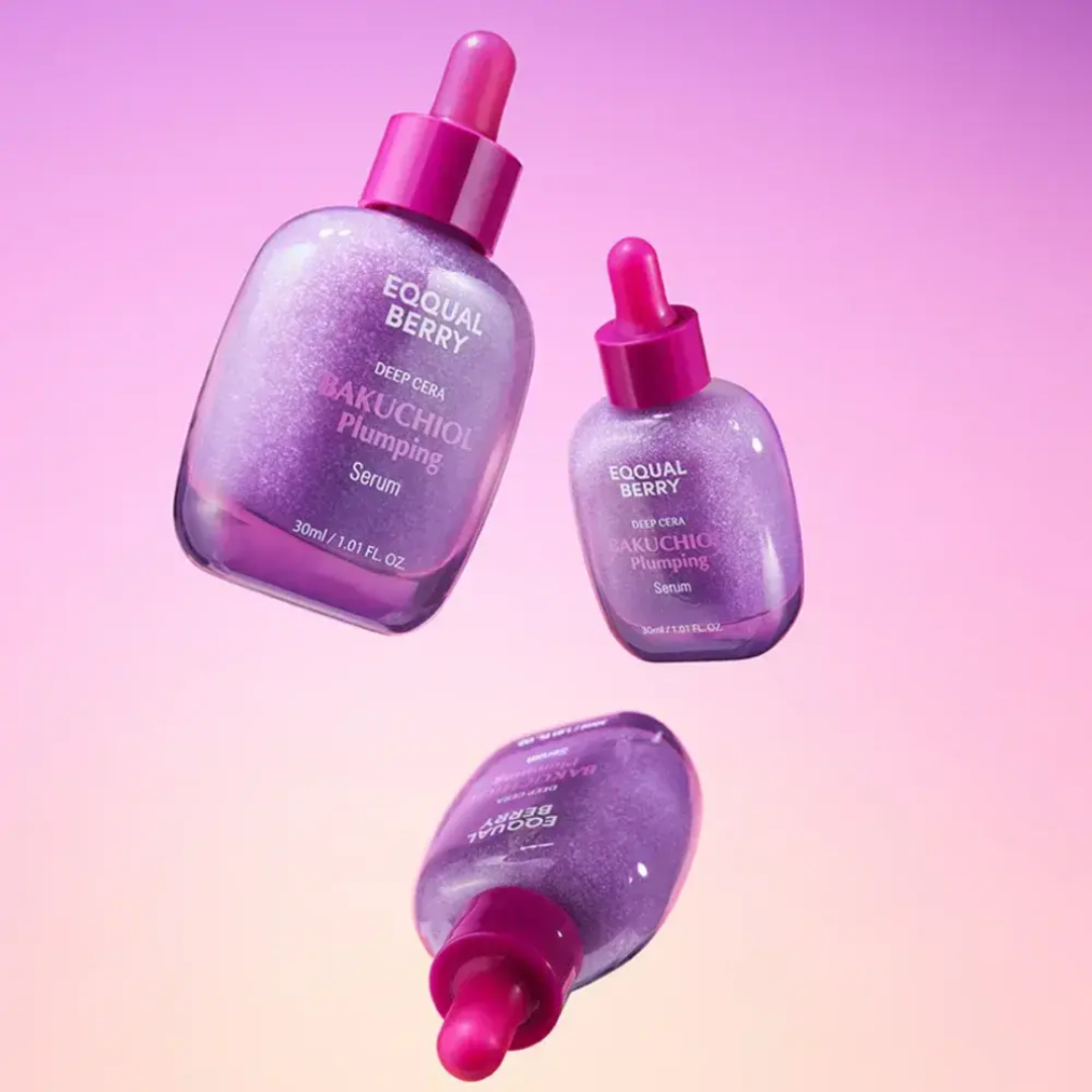 Three bottles of Equal Berry Bakuchiol Plumping Serum on a gradient pink and purple background.