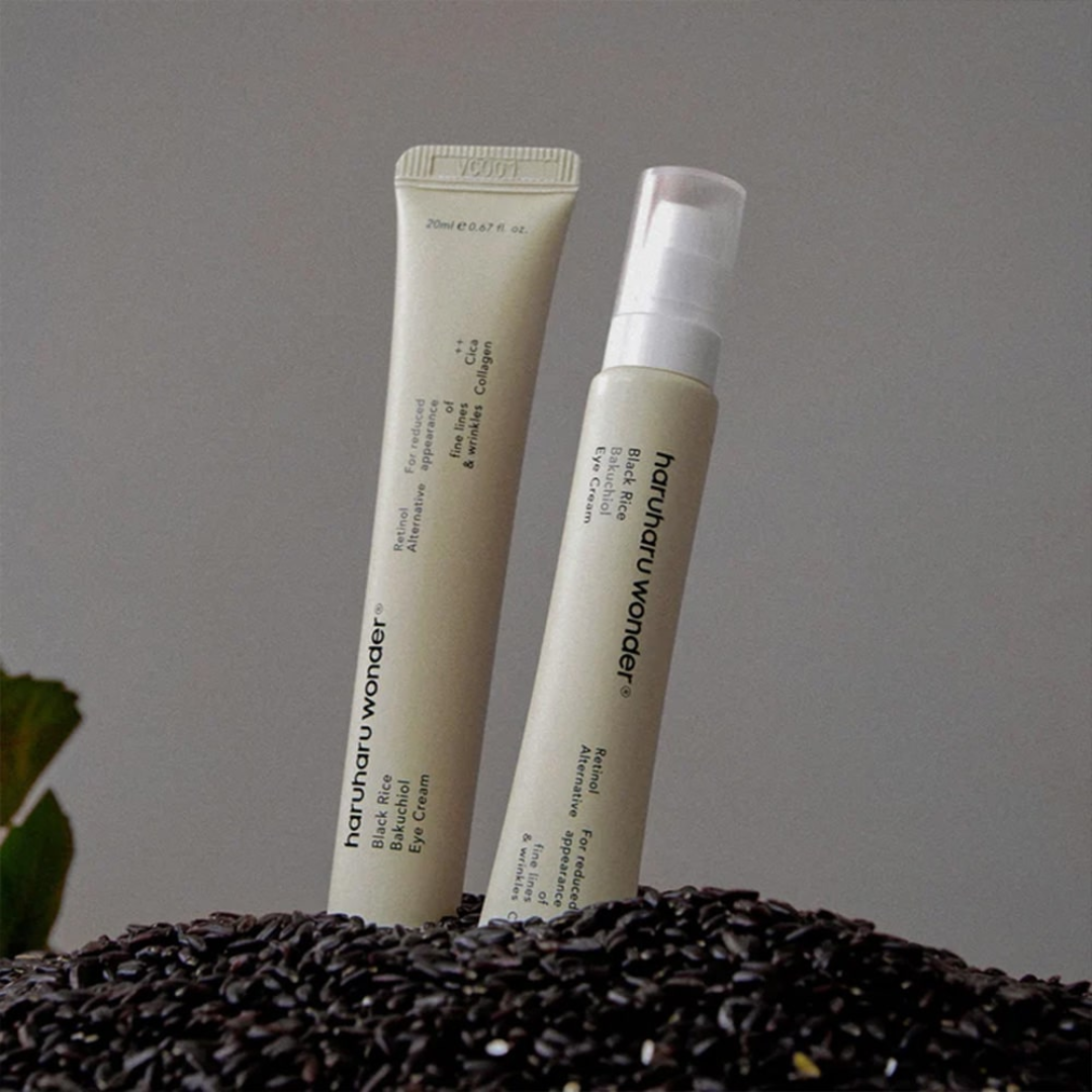 Two skincare products on a textured surface with a neutral background