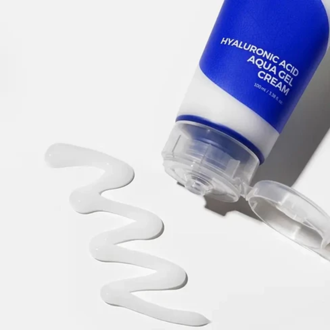 Blue and white skincare cream bottle with a swatch of cream on a light gray background