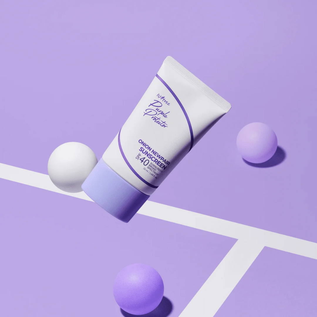 Tube of sunscreen with purple balls on a light purple background