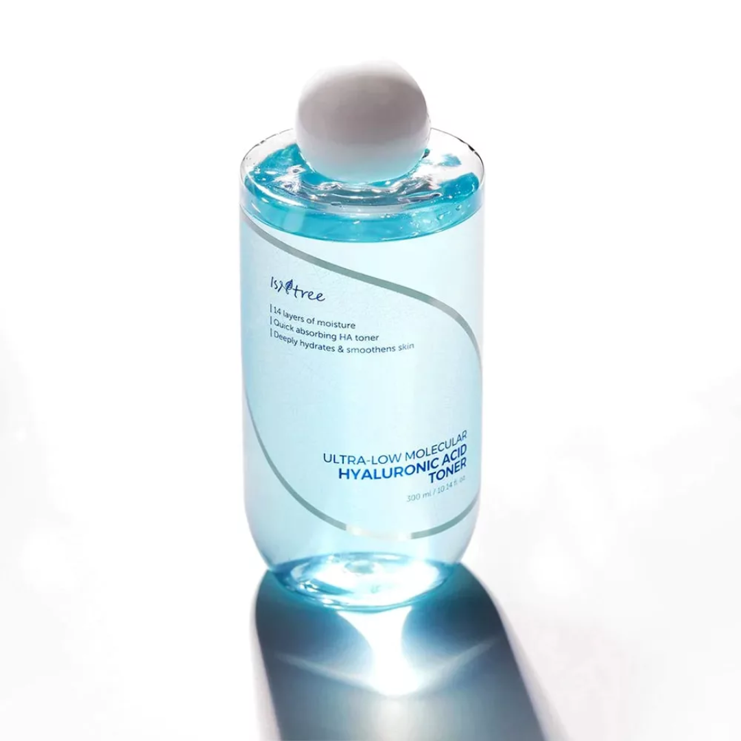 Bottle of skincare toner with a white cap on a white background