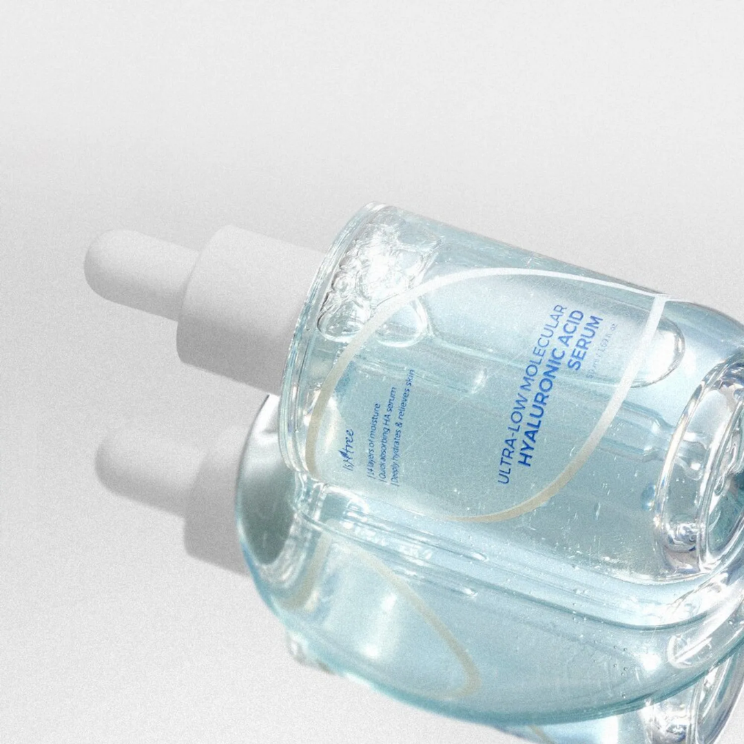 Skincare serum bottle with dropper on a light gray background