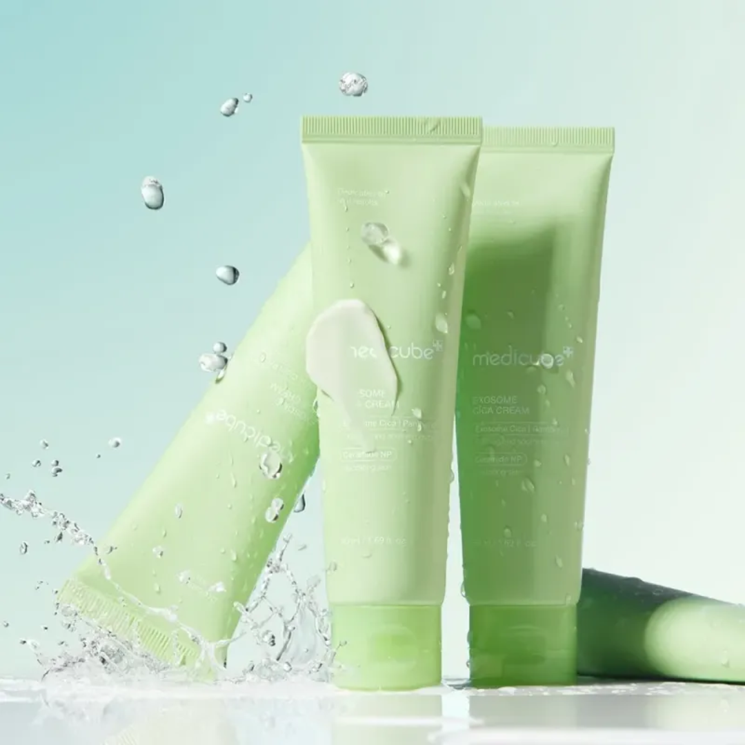 Two green skincare products with water droplets on a light blue background