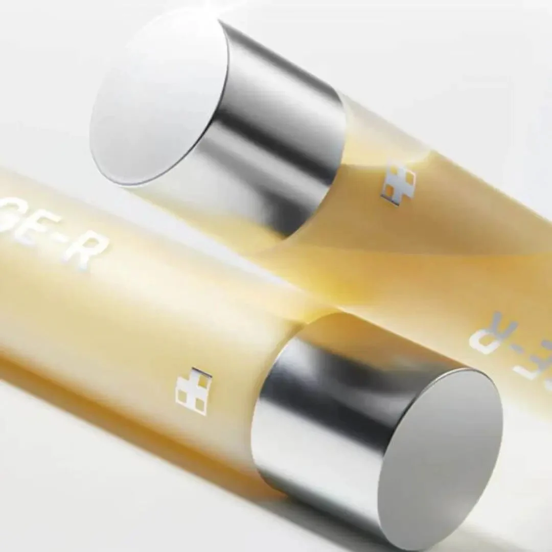 Close-up of a yellow and silver cylindrical product with a plus sign symbol.