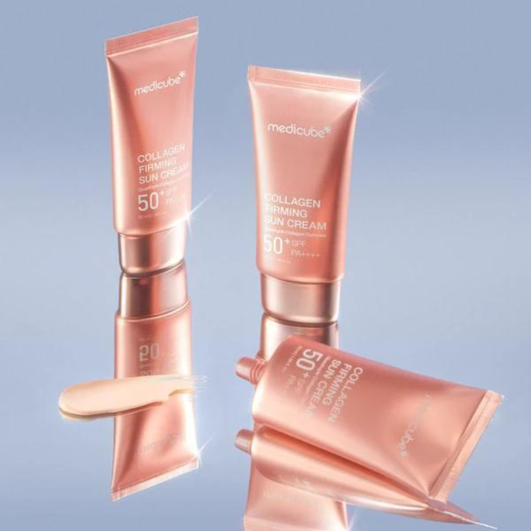 Two tubes of Medicube Collagen Firming Sun Cream on a reflective surface with a light blue background