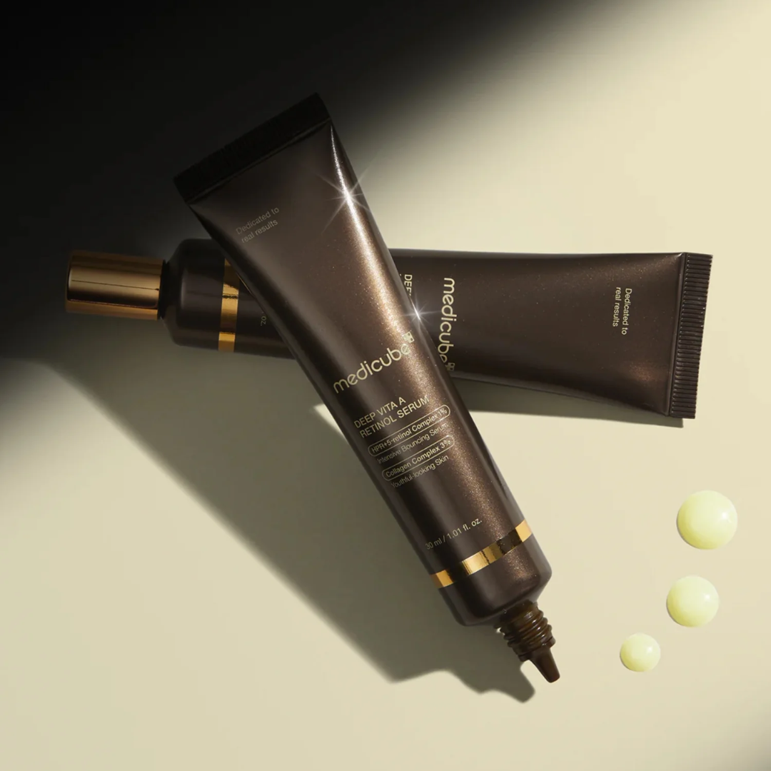 Skincare products including a tube and bottle on a neutral background