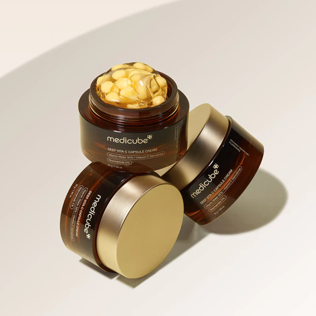 Three jars of Medicube cream on a light background