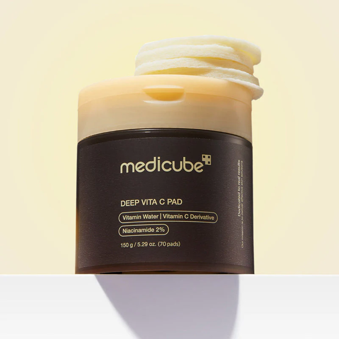 Medicube Deep Vita C Pad container on a light yellow background