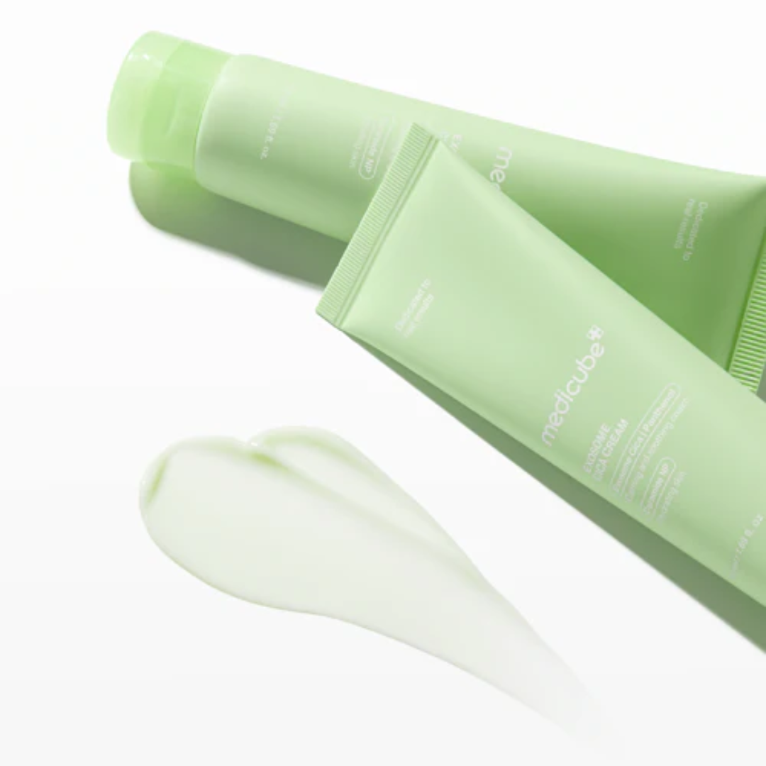 Green skincare product with applicator on a white background