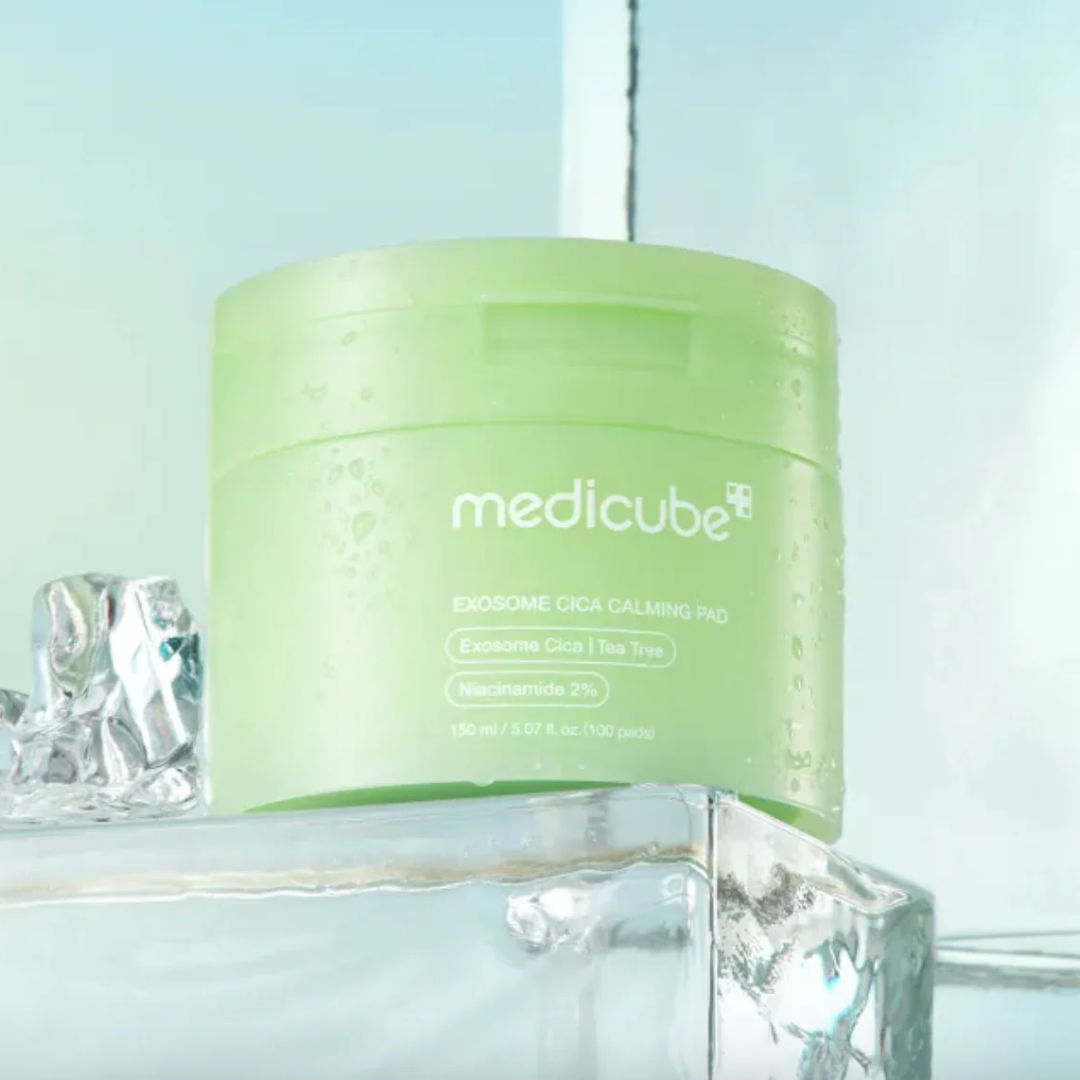 Green jar of Medicube product with ice cubes on a light blue background