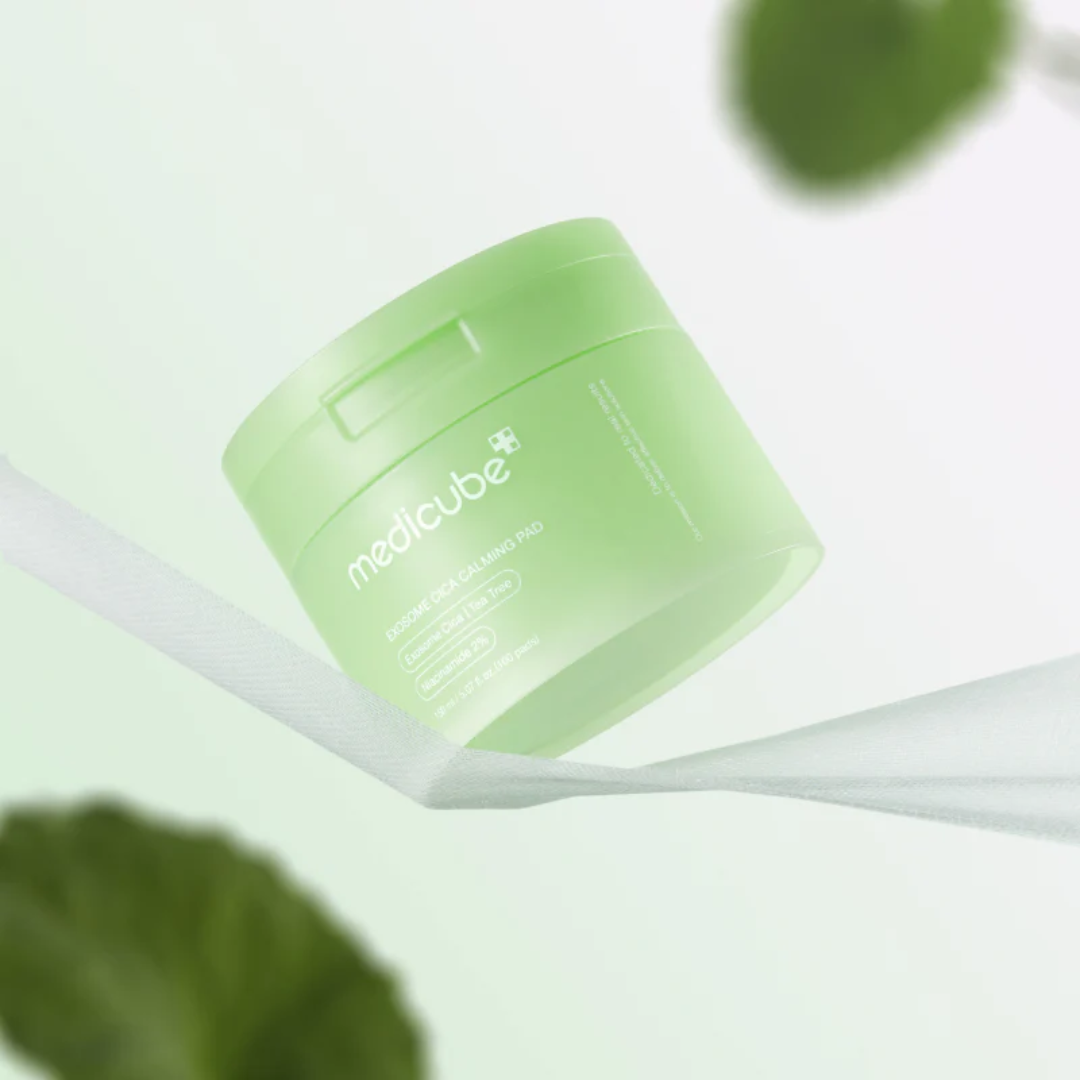 Green jar of Medicube product on a white background with leaves.