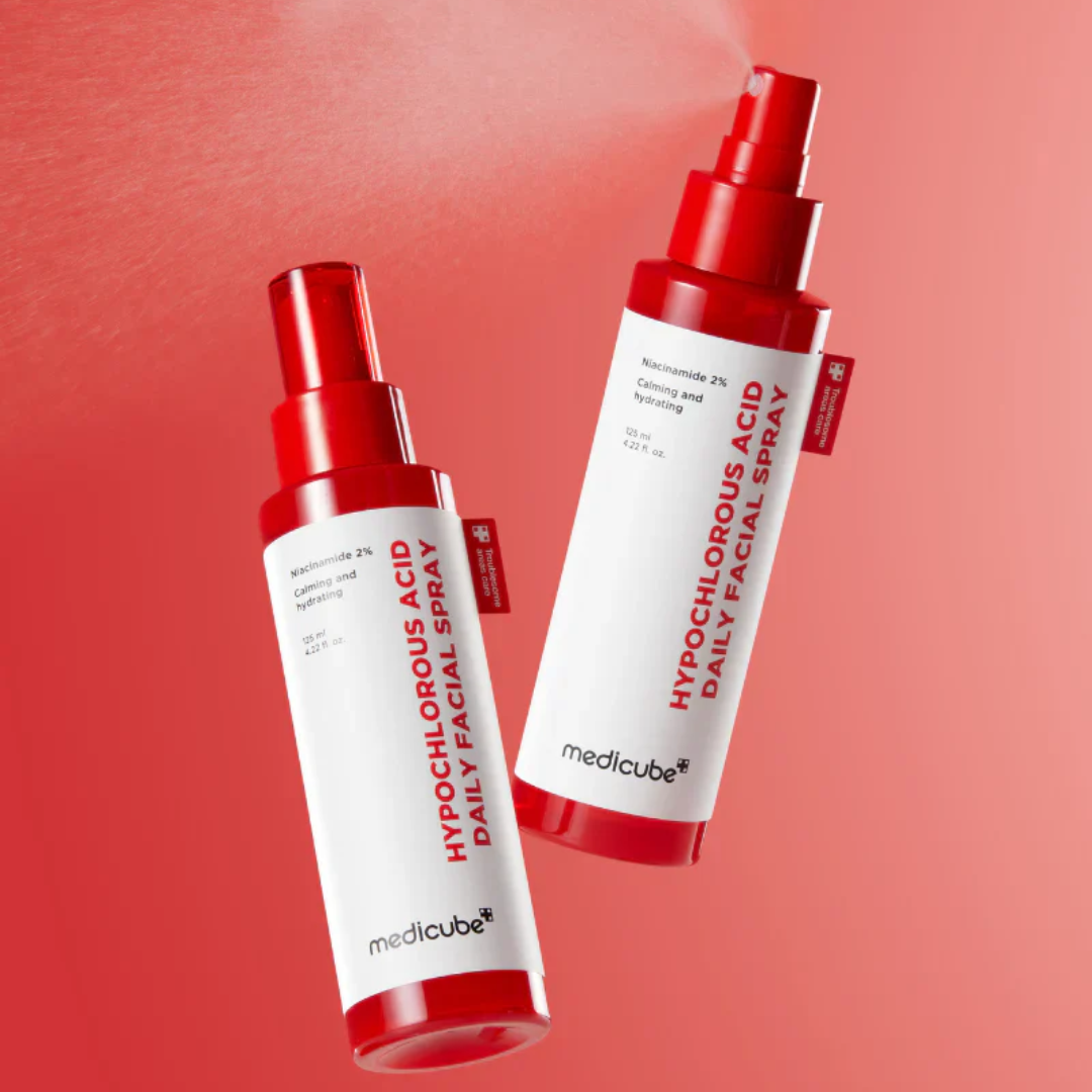 Two bottles of Medicube hypochlorous acid daily facial spray on a red background