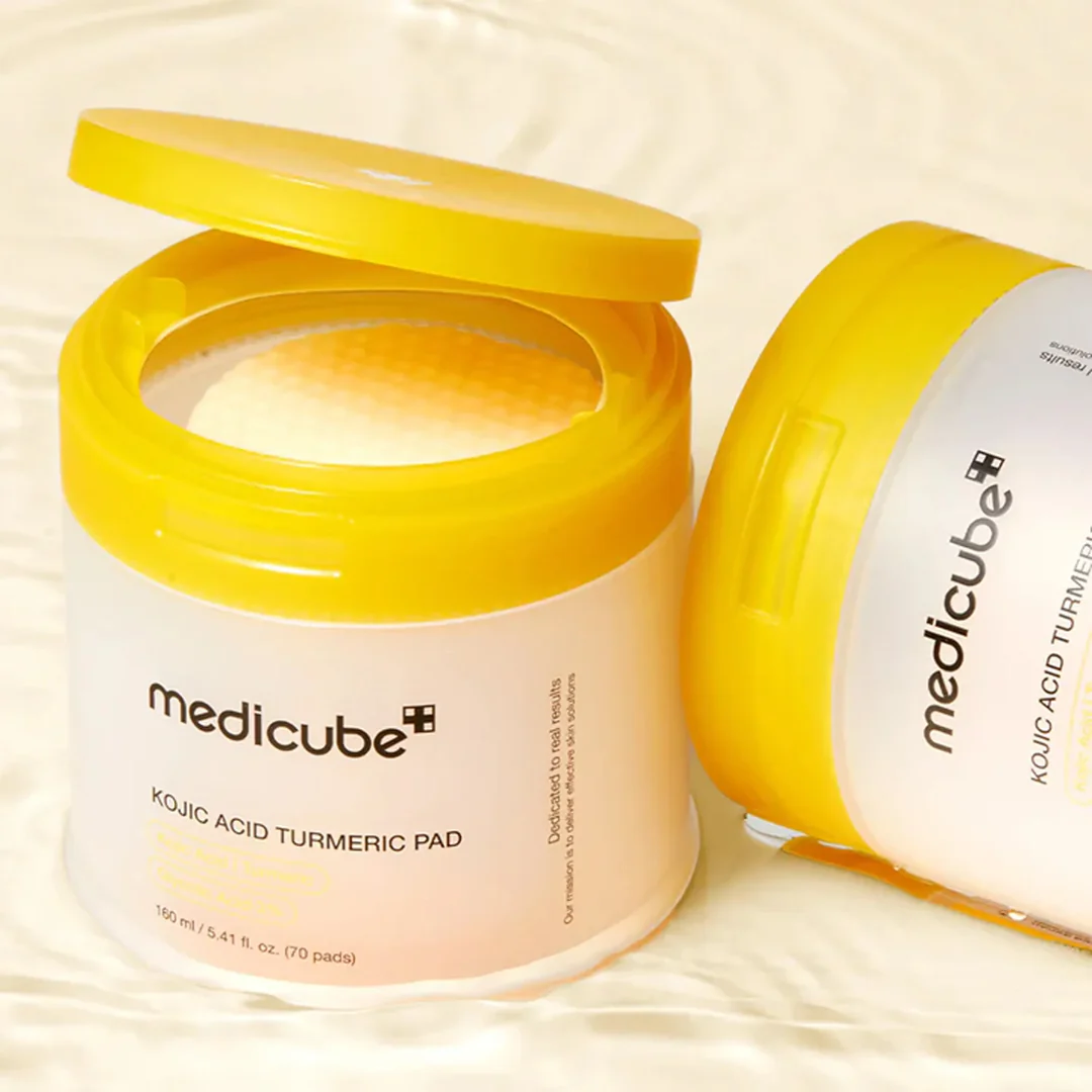 Two jars of Medicube Kojic Acid Turmeric Pad on a beige background